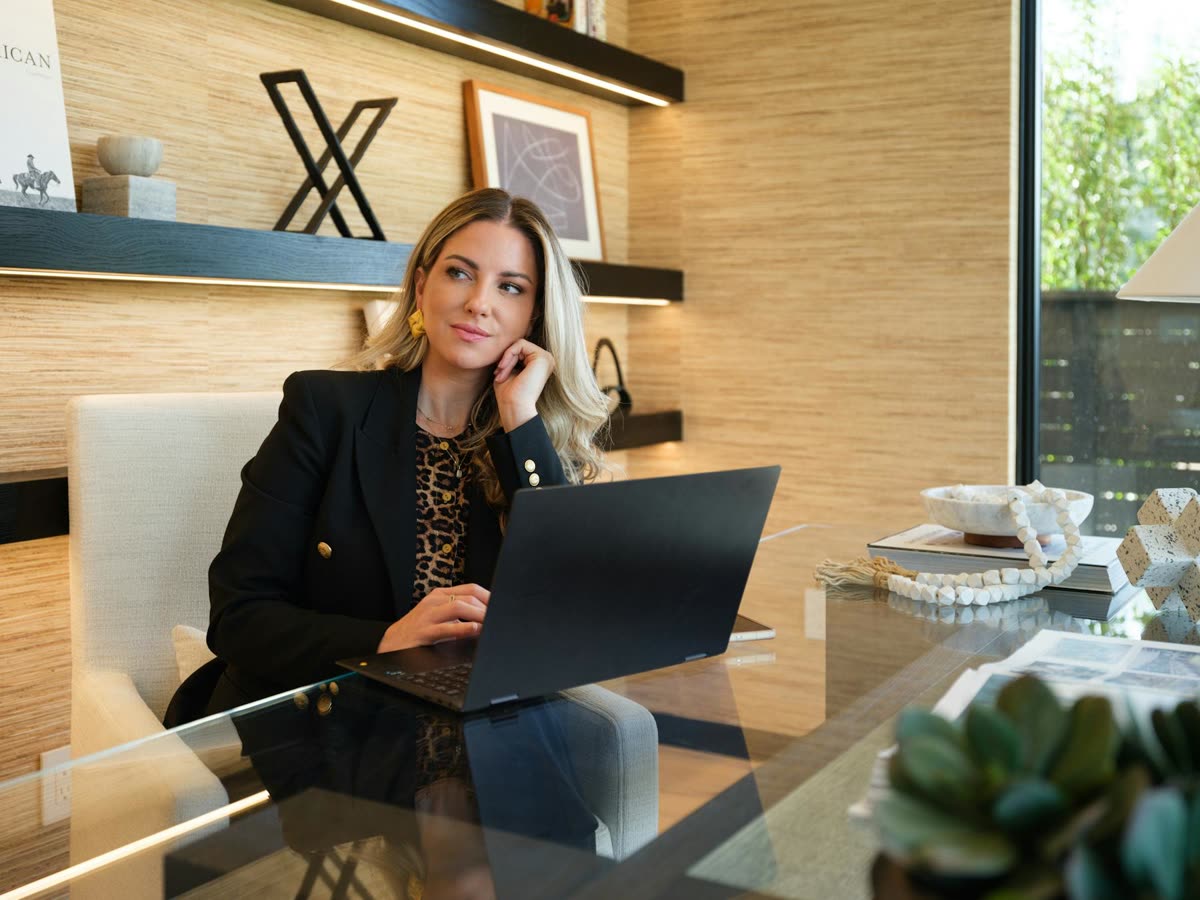 Annie at her desk, working on a laptop